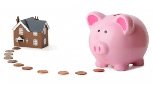 29117532 - piggy bank following money to a house isolated on a white background