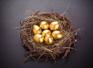 gold eggs in nest from hay on table