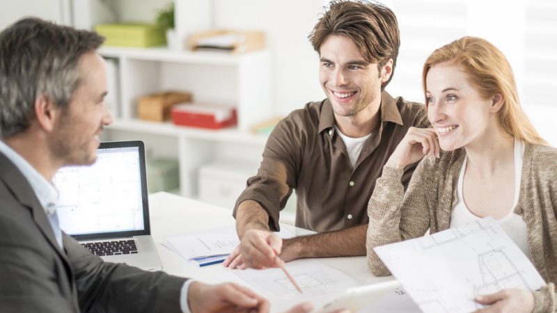 real-estate agent receives a young couple interested to invest i