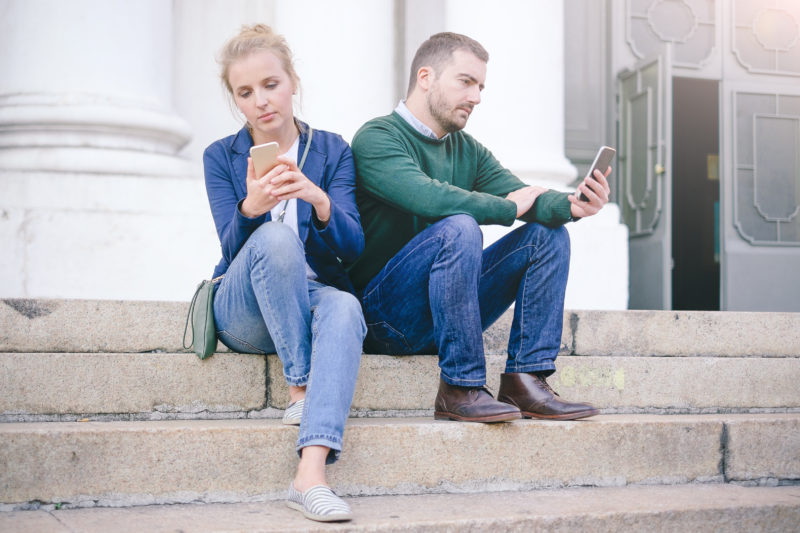 Bored Couple Chatting With Their Smart Phone