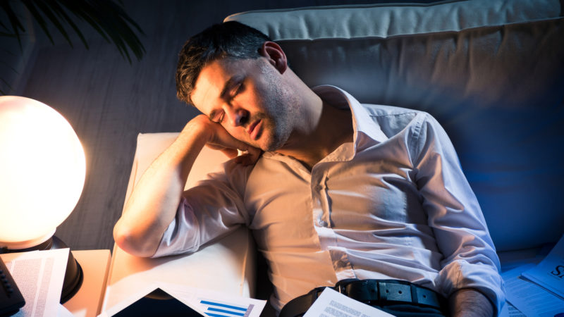 Overworked Businessman On Sofa